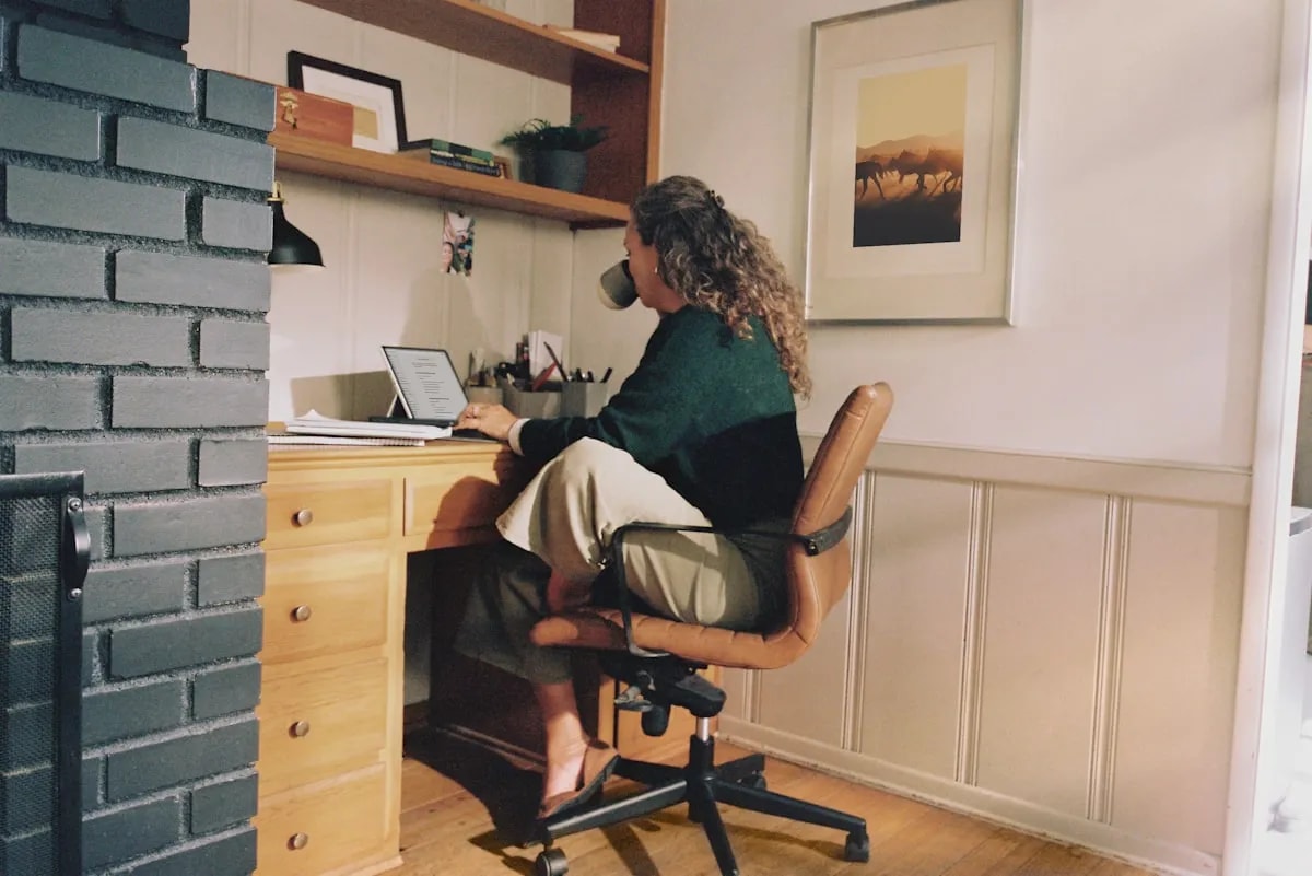 Remote employee working at a home desk, illustrating distributed team productivity tracking